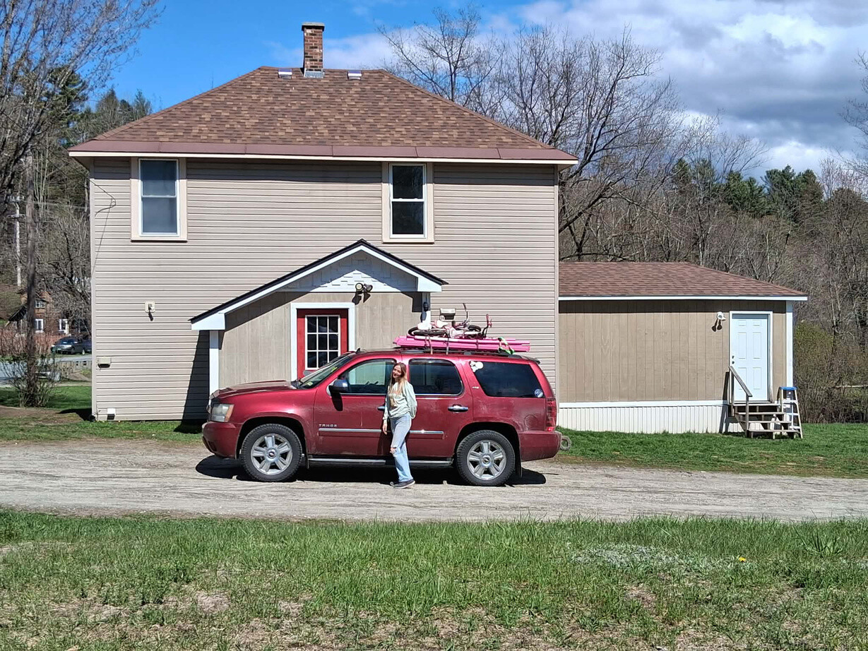 Allie Wood standing in front of her new home