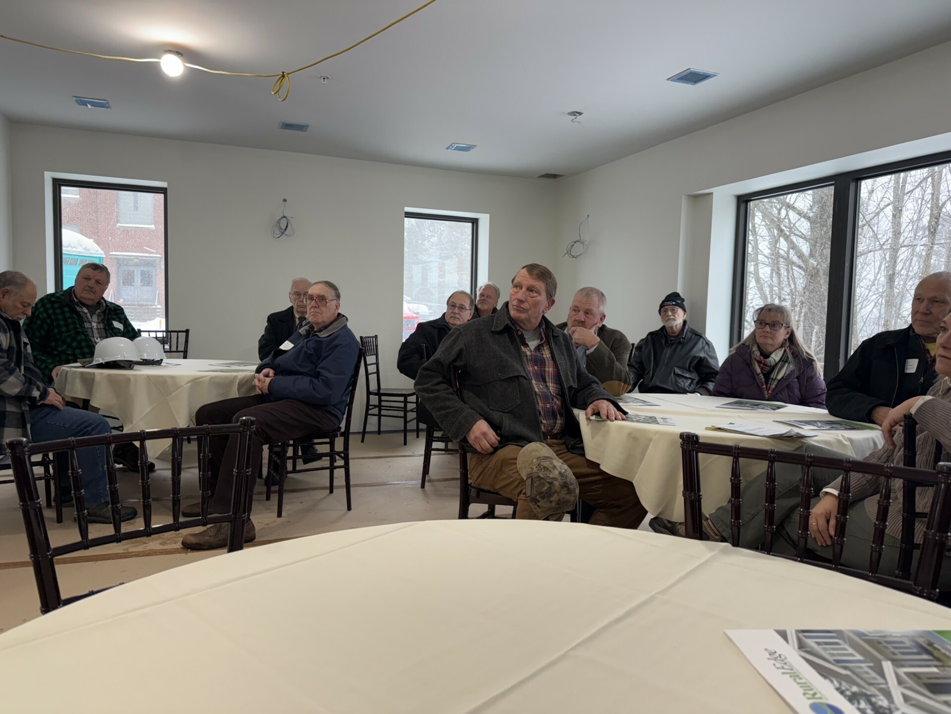 Representatives Page, Labor, Wells, Marcotte, Higley, Nelson and Campbell listen as RuralEdge Executive Director Patrick Shattuck delivers opening remarks during a Dec. 2 tour of Newport Crossing.